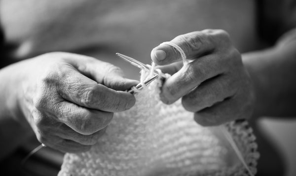 Hand knitting close-up, black and white